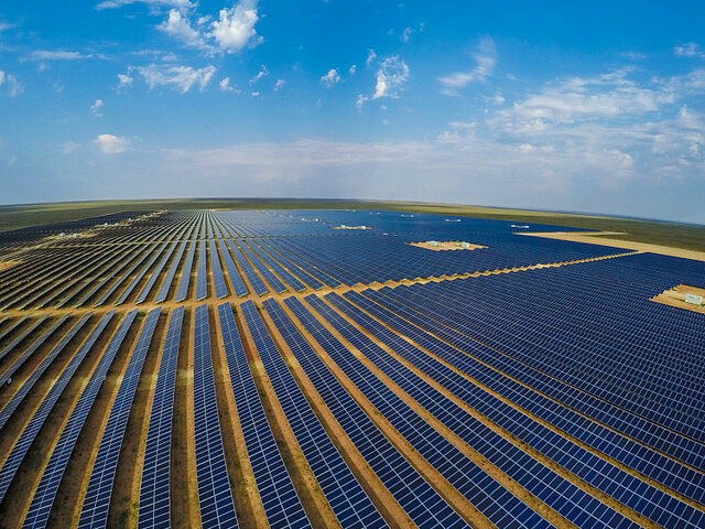 A large solar plant stands in the sun and produces electricity.
